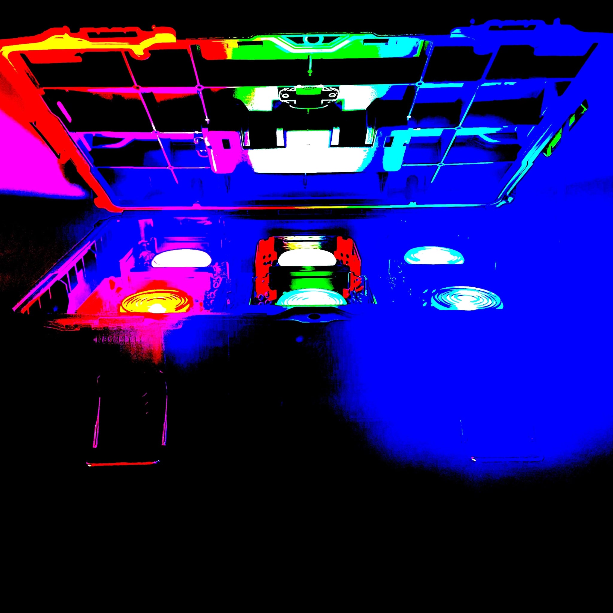 6 Z-RAY Wireless DMX Lights with Fresnel lenses, displaying a range of colours, inside a nearly-closed tough box.