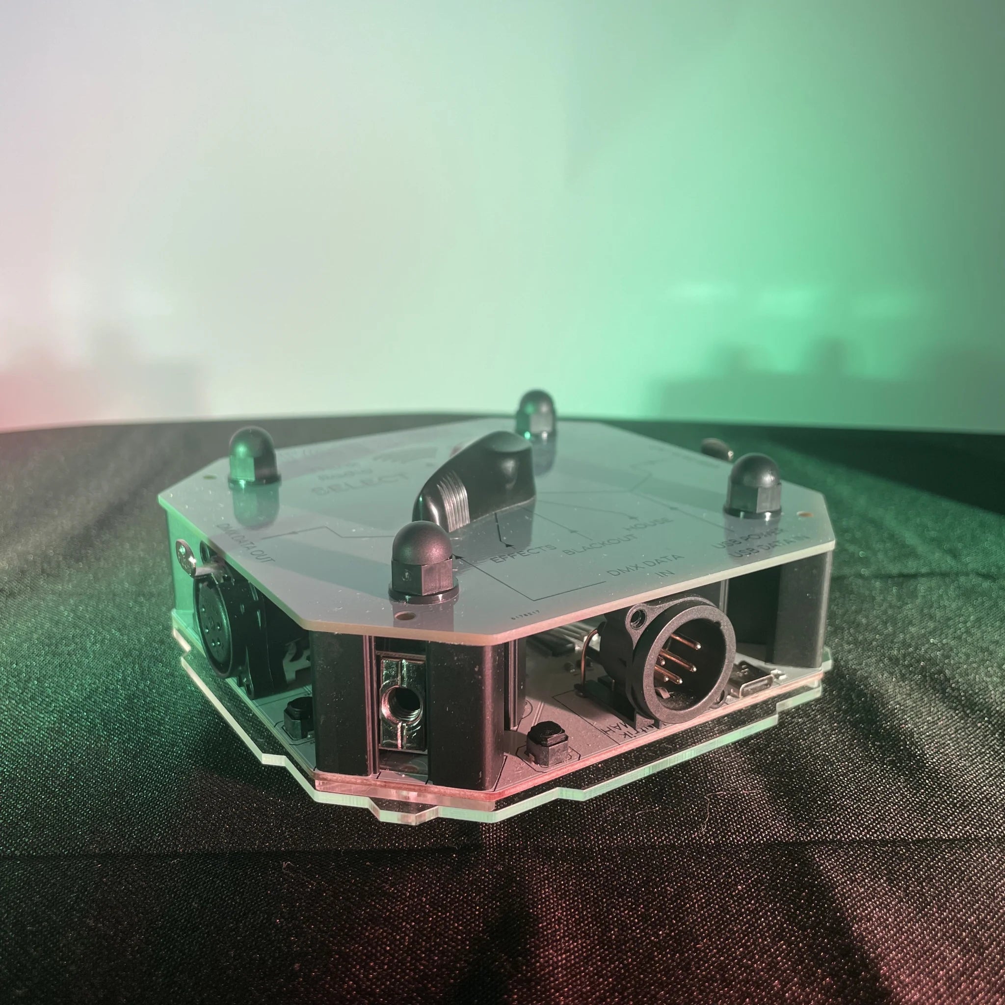 A naked STATION-X, without side-panels, showing the rotary input selector, and the USB-C power/data input, XLR5 Female DMX input, and one XLR5 DMX output.