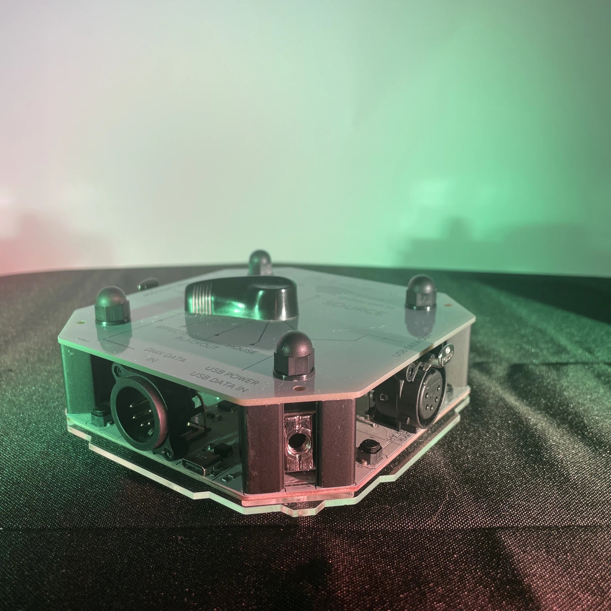 Close up of connectors on STATION-X, showing USB-C data and power input, XLR5 Female DMX data input, and an XLR5 Male DMX data output.